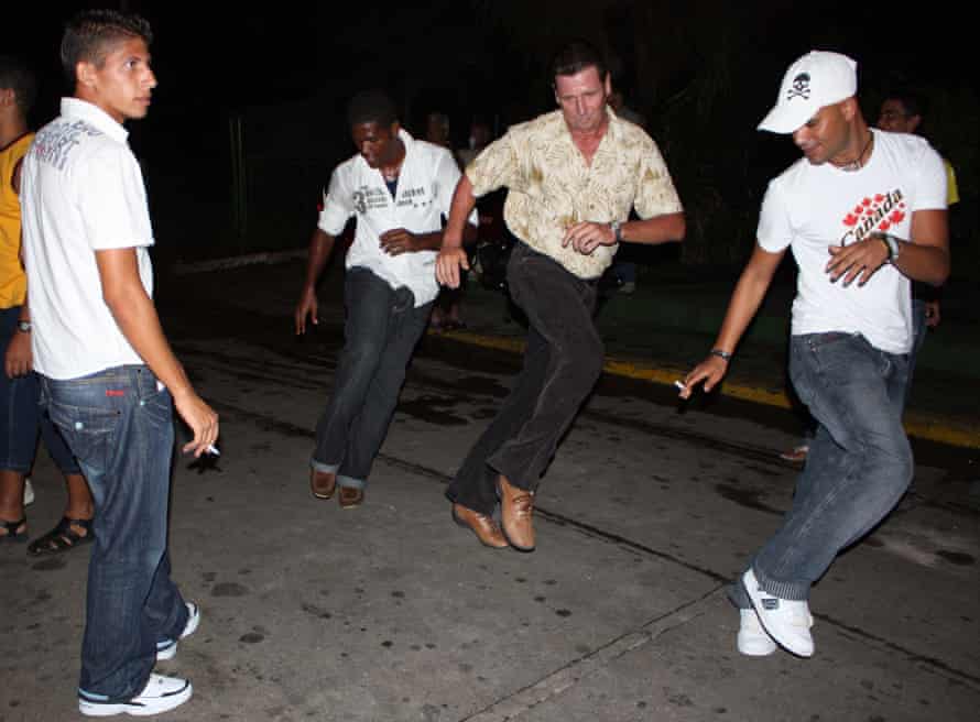 Locals dance on the street in Matanzas, Cuba.