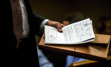 Special agent Jeff Seipenko walks out of the courtroom with signed paperwork authorizing charges Wednesday in Flint, Michigan.
