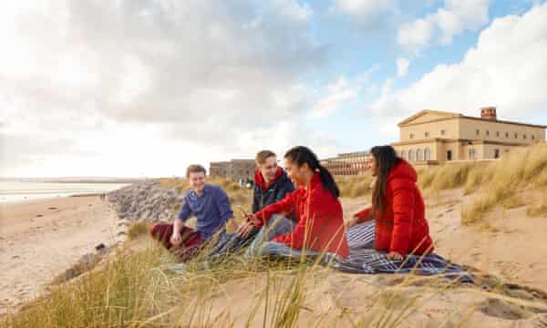 Students sitting at the bay campus at Swansea University