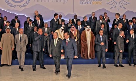 Egypt's President Abdel Fattah al-Sisi and United Nations Secretary General Antonio Guterres walk together after world leaders had their group picture taken ahead of their summit at the COP27 climate conference