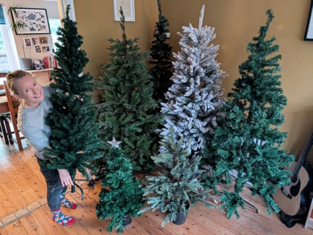 Jane Hoskyn with a selection of artificial Christmas trees in her front room