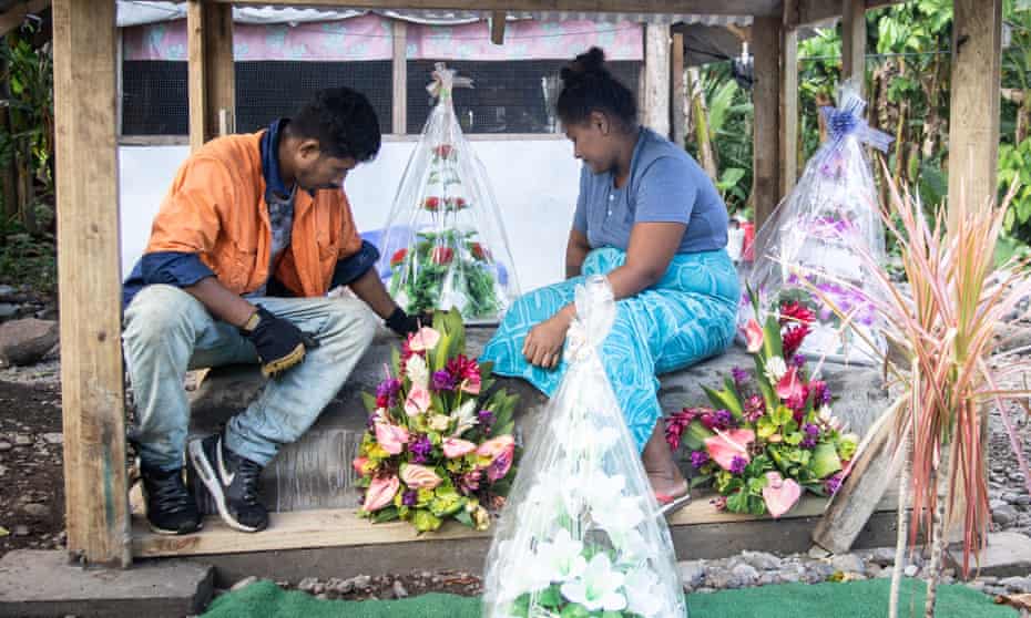 Fa’aoso Tuivale and her husband, Tuivale Luamanuvae Puelua sit on their children’s graves in Lauli’i, Samoa.