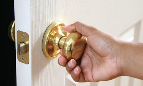 Hand turning a doorknob.