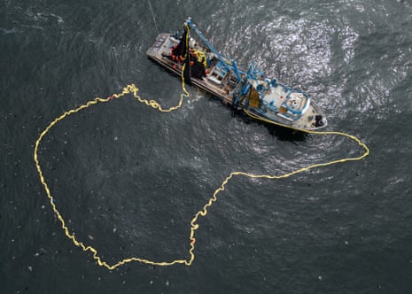 Aerial shot of a fishing boat as it puts out a huge net