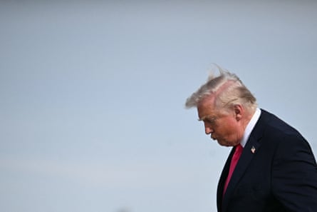 a man in a suit looks down