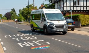 An ambulance passes a Thank You NHS sign in Slough.