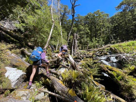 Children hike across a river