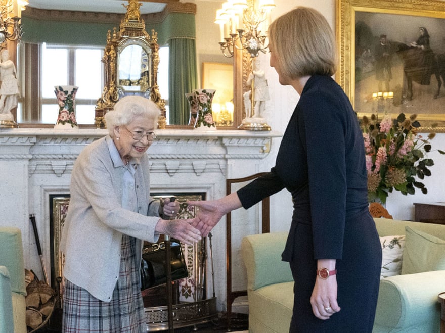 The Queen in a cardigan and skirtshaking hands with Liz Truss in Balmoral’s living room