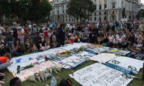 Hundreds of people gather in Parliament Square to create a memorial and pay tribute to the victims of the Grenfell Tower fire on June 19, 2017 in London