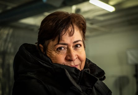 Woman wearing a coat looking at the camera.