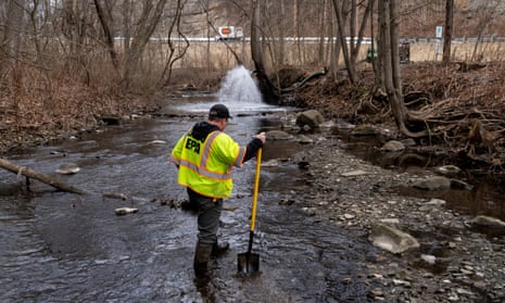 Ron Fodo, from Ohio EPA Emergency Response, inspects a creek on 20 February 2023 in East Palestine, Ohio. 