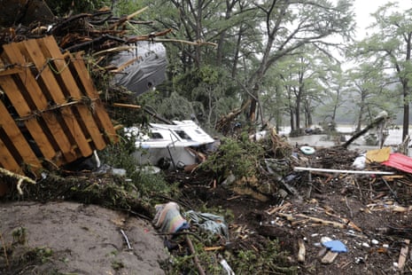 Damaged vehicles and debris are seen roped off near the banks of the Guadalupe River after flooding in Ingram, Texas.