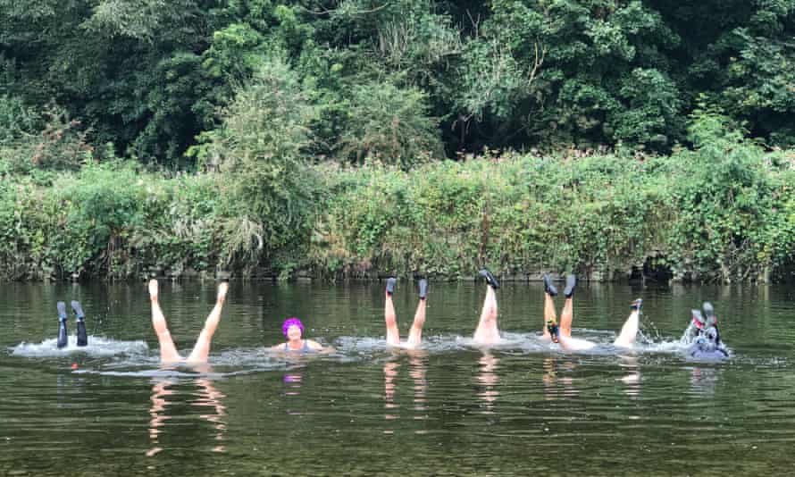 women doing handstands in river