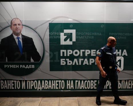 A member of the Gendarmerie special police stands guard in front of the Progressive Bulgaria party headquarters after countrywide polls have closed in Sofia, Bulgaria.