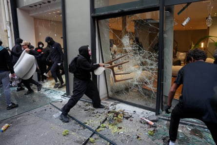 Rioters looting a shop in Paris.