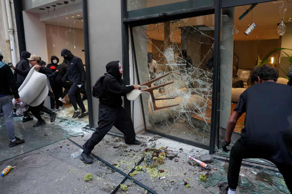 Rioters looting a shop in Paris.