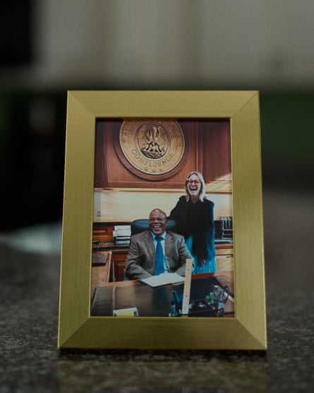 A framed photograph of Calvin Duncan smiling at his desk next to a laughing blond woman