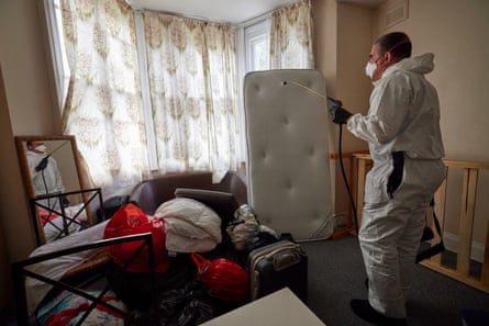 Pest controller Tony King spraying a room for bedbugs