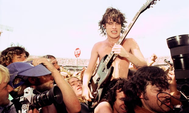 Angus Young and Bon Scott doing the Shoulder Ride at the Oakland Coliseum 1978 in Oakland, California.
