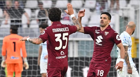 Torino guardant Giovanni Simeone celebrates pinch defender Luca Marianucci