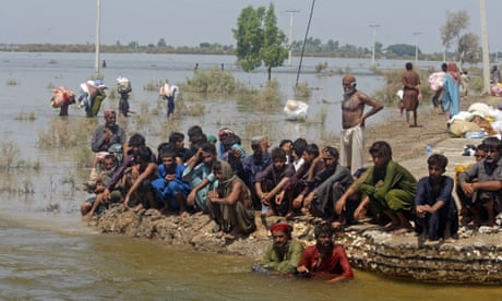 Victims of heavy flooding from monsoon rains wait to receive relief aid in the Qambar Shahdadkot district of Sindh province, Pakistan.