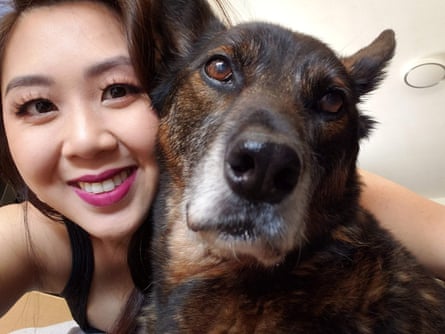 a woman smiles with her dog