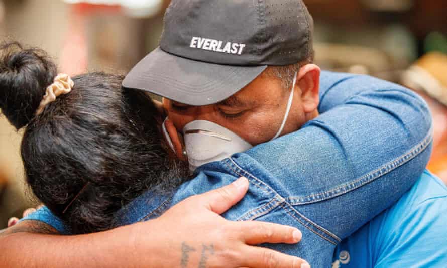 Passengers and loved ones reunite in the arrivals hall of Auckland airport.