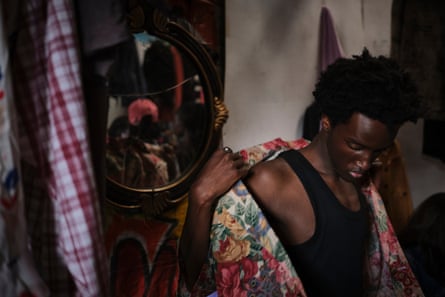 A man is helped into a floral shirt