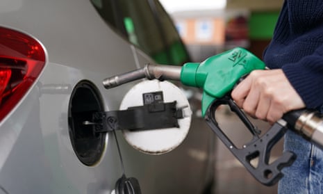 Person filling up car with petrol.