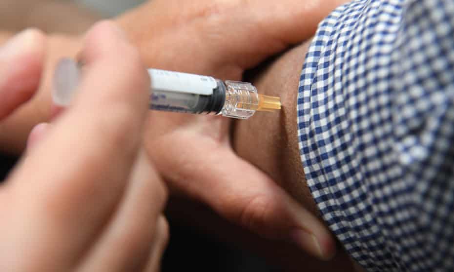 A man receives a flu shot