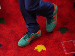 Colourful trainers on a carpet featuring a maple leaf motif