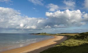 Dunstanburgh Castle in the distance beyond the sands of Embleton Bay