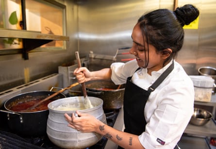 Kumkum Kalam using a wooden spoon to mix a large pot