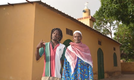 A rastafarian stands with Lassa’s Imam outside the village mosque.