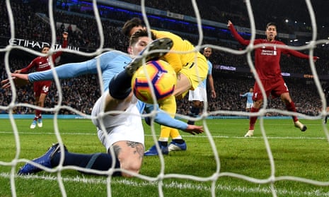 John Stones of Manchester City makes a goal-line clearance during a Premier League match against Liverpool