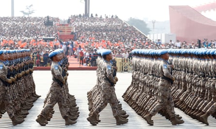 Chinese troops march in formation past Tiananmen Square.
