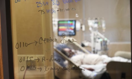 Medical notations are written on a window of a Covid-19 patient’s room in an intensive care unit at the Willis-Knighton Medical Center in Shreveport, Louisiana, on 18 August.