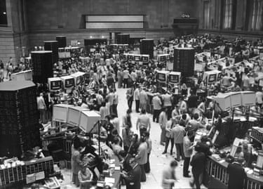 People stand in a room full of television displays