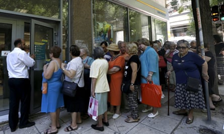 People wait outside a bank in Athens to receive part of their pensions on Thursday.