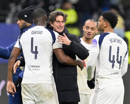 The Spurs manager Thomas Frank celebrates with Kevin Danso