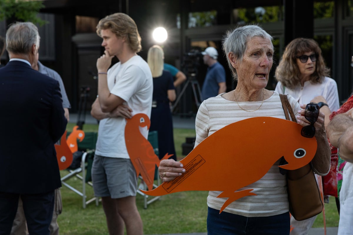 Community members held orange cockatoo signs at a Wodonga vigil for Helen Haines on Wednesday