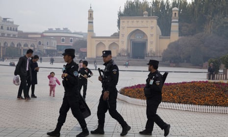 Uighur security personnel patrol near the Id Kah Mosque in Kashgar. Spending on security-related construction jumped 213% in 2017.