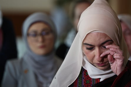 Dr Bushra Othman wipes away a tear during a press conference at Parliament House on Tuesday.
