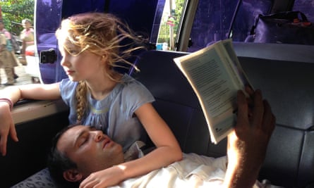 Ben Goldsmith reads a book while resting his head on Iris