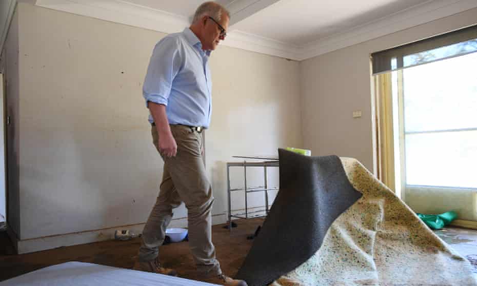 Scott Morrison visits a flood-damaged home in Sydney.