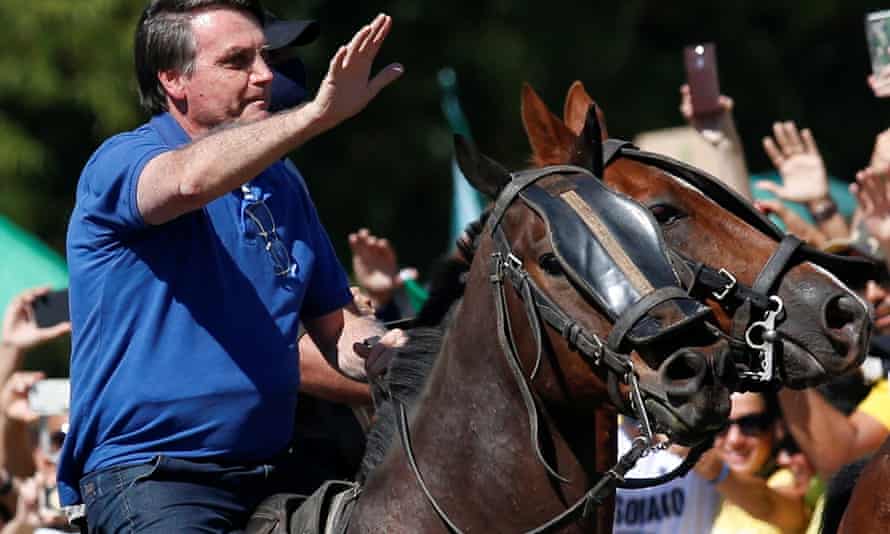 Brazil’s president Jair Bolsonaro rides a horse during a meeting with supporters protesting in his favour, amid the coronavirus outbreak, in Brasilia, Brazil on 31 May.