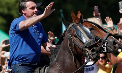 Brazil’s president Jair Bolsonaro rides a horse during a meeting with supporters protesting in his favour, amid the coronavirus outbreak, in Brasilia, Brazil on 31 May.