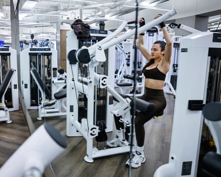 A woman works out on a weight machine in a Boston gym.