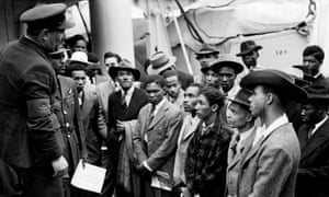Jamaican immigrants are greeted by RAF officials after the Empire Windrush lands in the UK.