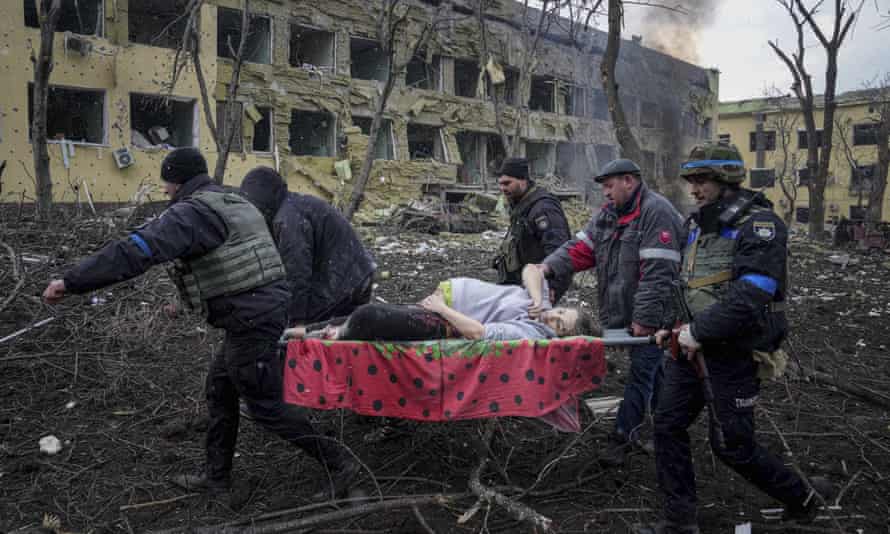 Emergency workers and volunteers carry an injured pregnant woman from a maternity hospital that was damaged by shelling in March.